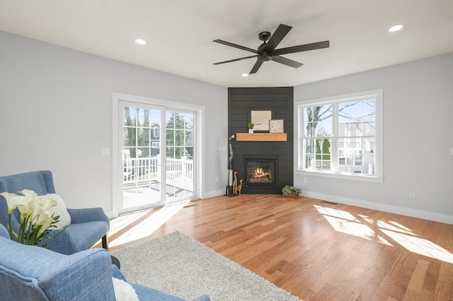 117 Montvale Ave, Woburn, MA 01801 - living room featuring healthy amount of natural light, a large fireplace, baseboards, a ceiling fan, and recessed lighting