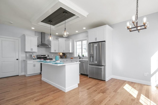 117 Montvale Ave, Woburn, MA 01801 - kitchen with stainless steel appliances, wall chimney exhaust hood, light countertops, a sink, and a chandelier