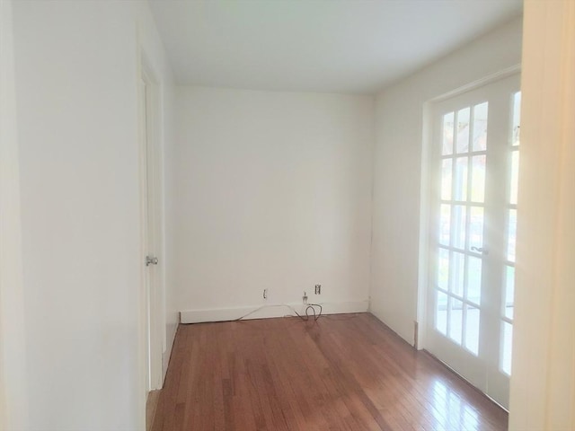 spare room featuring wood finished floors