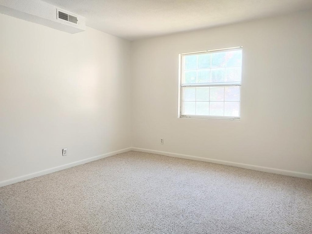 carpeted spare room with baseboards
