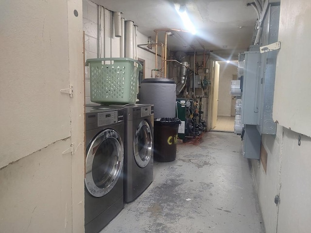 unfinished basement with separate washer and dryer and a heating unit