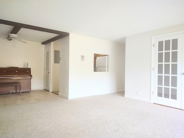unfurnished living room featuring carpet, a ceiling fan, and baseboards