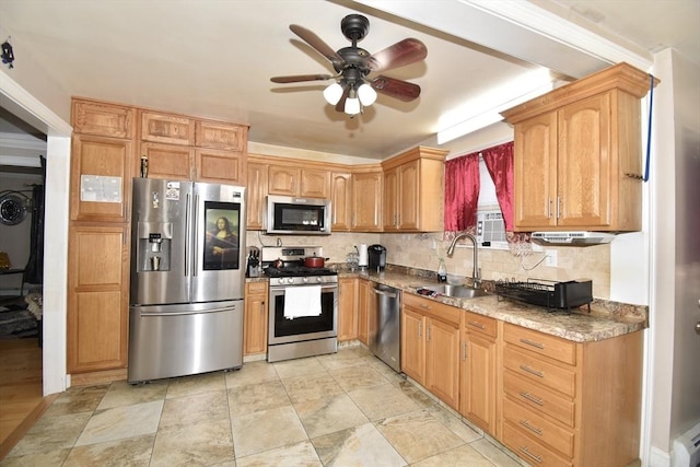 kitchen featuring stainless steel appliances, a sink, ceiling fan, and backsplash