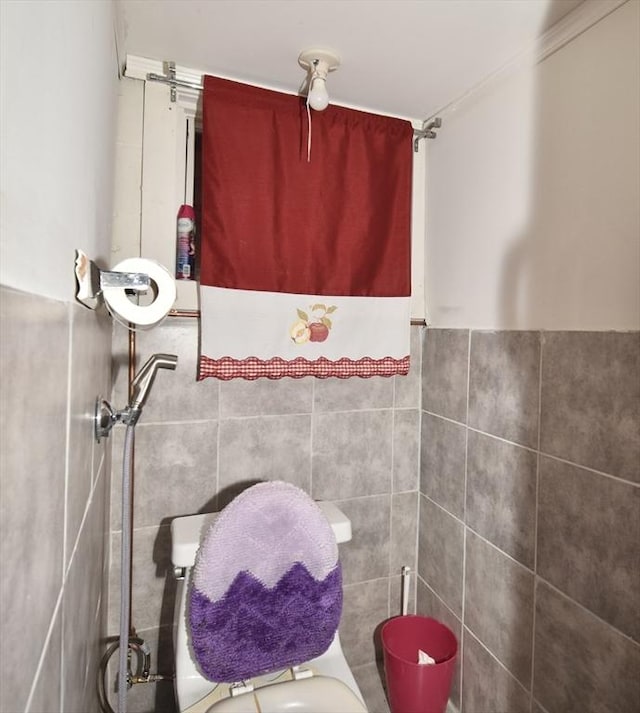 bathroom with tile walls