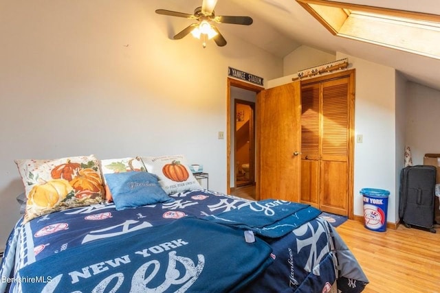 bedroom with lofted ceiling, ceiling fan, and hardwood / wood-style floors