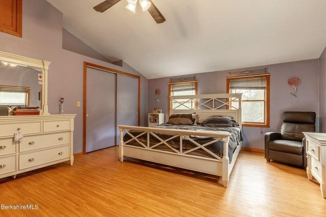 bedroom with ceiling fan, a closet, lofted ceiling, and light hardwood / wood-style flooring