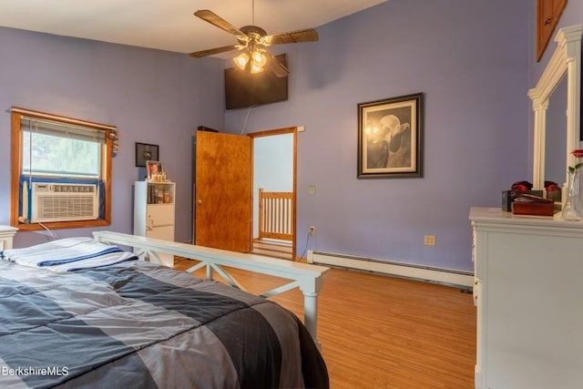 bedroom featuring ceiling fan, baseboard heating, and cooling unit