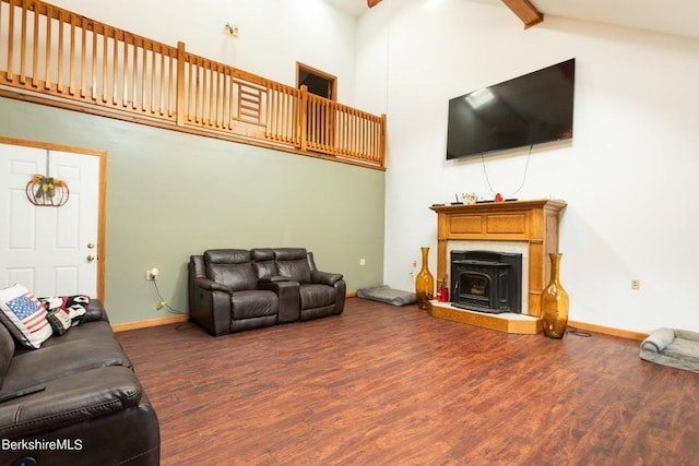 living room with dark hardwood / wood-style flooring and vaulted ceiling with beams