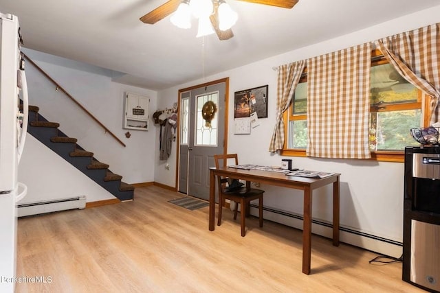 foyer featuring light hardwood / wood-style floors, a baseboard radiator, plenty of natural light, and ceiling fan