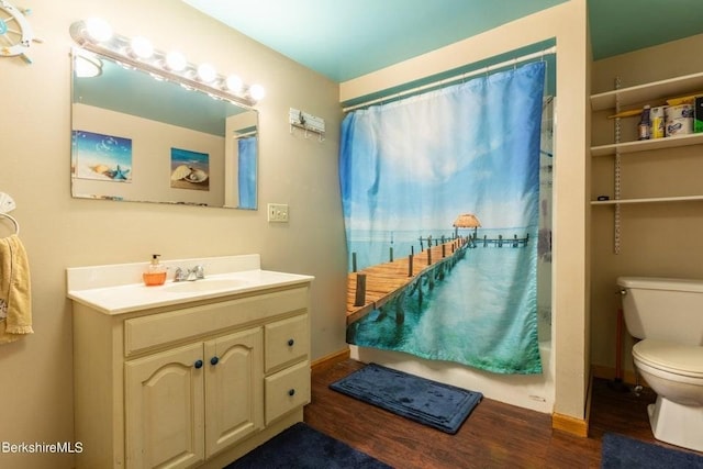 bathroom featuring toilet, vanity, walk in shower, and hardwood / wood-style floors