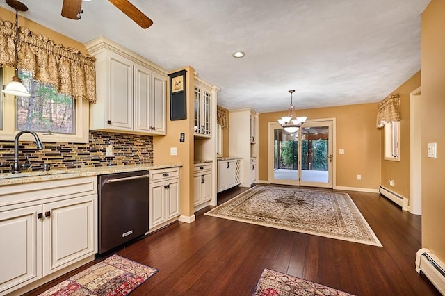 kitchen with pendant lighting, stainless steel dishwasher, baseboard heating, and dark wood-type flooring