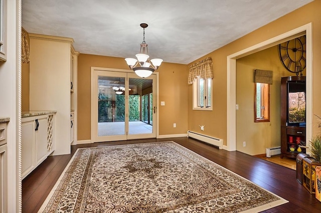 entryway featuring baseboard heating, dark wood-type flooring, and a notable chandelier