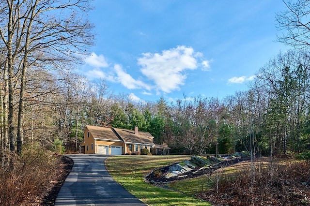 exterior space with a yard and a garage