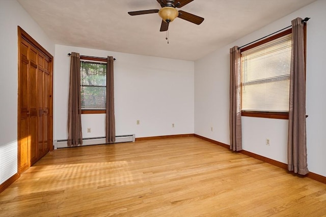 unfurnished bedroom featuring ceiling fan, light hardwood / wood-style floors, and a baseboard radiator