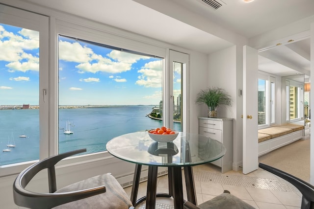 interior space with a water view and light tile patterned floors