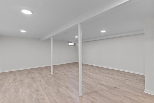 finished basement with recessed lighting, baseboards, and light wood-type flooring