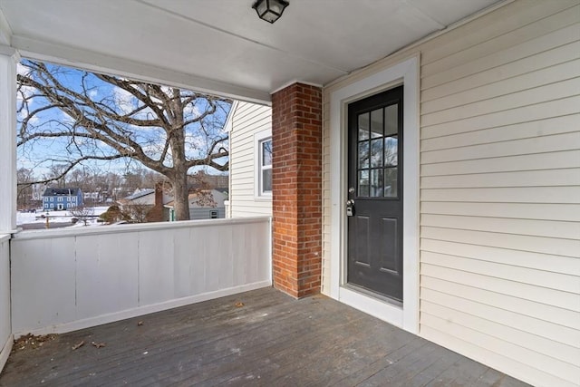 view of exterior entry with a deck