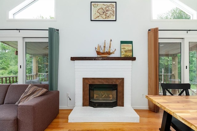 10 Longmeadow Ln, Medway, MA 02053 - living room with wood finished floors, a brick fireplace, and plenty of natural light