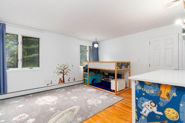 10 Longmeadow Ln, Medway, MA 02053 - interior space with wood finished floors, healthy amount of natural light, and baseboard heating