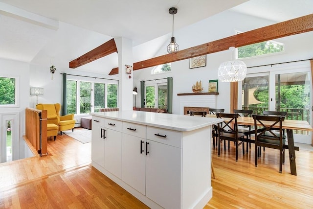 10 Longmeadow Ln, Medway, MA 02053 - kitchen with open floor plan, pendant lighting, light countertops, light wood-style floors, and beam ceiling