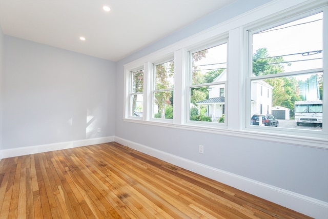 empty room with light hardwood / wood-style flooring