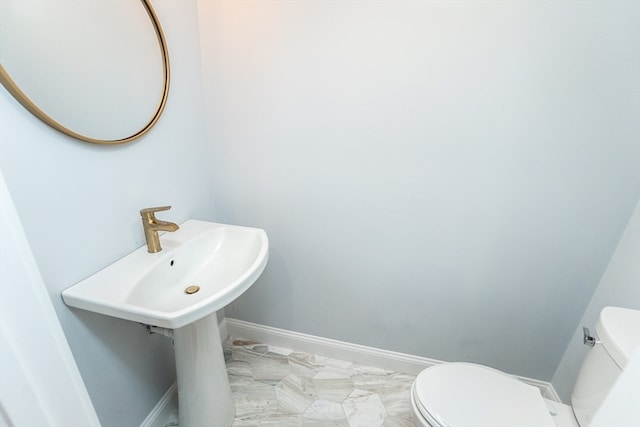 bathroom with tile patterned flooring and toilet