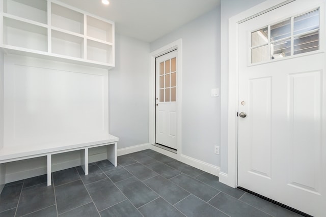 mudroom featuring dark tile patterned flooring