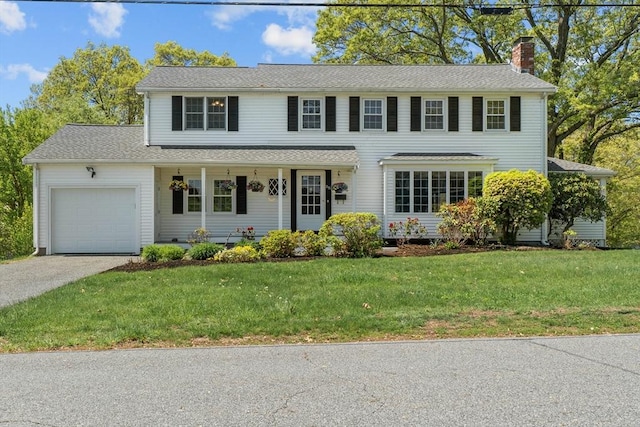 35 Crest Rd, Framingham, MA 01702 - colonial house with a chimney, a garage, driveway, a front lawn, and a porch