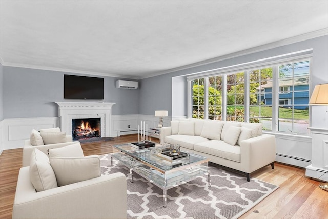 35 Crest Rd, Framingham, MA 01702 - living room featuring a wall unit AC, crown molding, a fireplace, baseboard heating, and light wood-style flooring