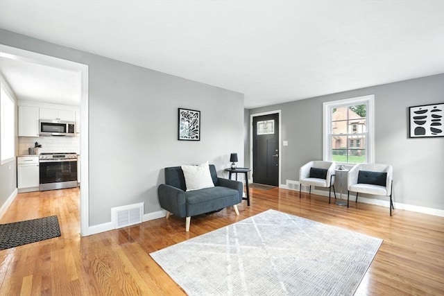 132 Nelson St, West Springfield, MA 01089 - sitting room with light wood finished floors and baseboards