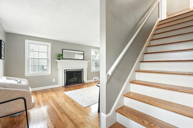 132 Nelson St, West Springfield, MA 01089 - stairway featuring wood finished floors and a fireplace with flush hearth