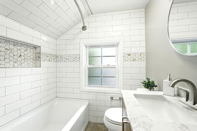 132 Nelson St, West Springfield, MA 01089 - full bath with a bath, plenty of natural light, vaulted ceiling, vanity, and tile walls