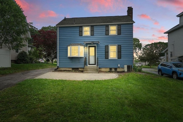 132 Nelson St, West Springfield, MA 01089 - view of front facade featuring entry steps, a chimney, and a yard