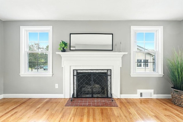 132 Nelson St, West Springfield, MA 01089 - unfurnished living room with wood finished floors and a fireplace with flush hearth