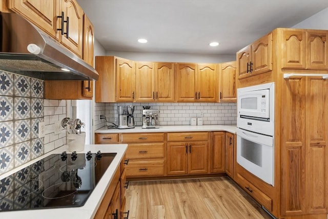 649 Robin Hill St, Marlborough, MA 01752 - kitchen featuring white appliances, under cabinet range hood, light wood-style floors, light countertops, and backsplash