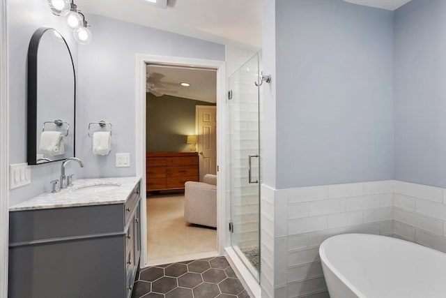 649 Robin Hill St, Marlborough, MA 01752 - bathroom with ensuite bath, a shower stall, a freestanding tub, tile patterned floors, and vanity