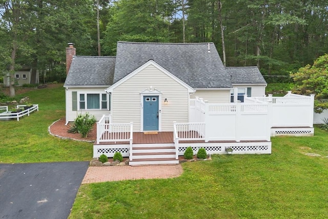 649 Robin Hill St, Marlborough, MA 01752 - view of front of home with a chimney, a deck, roof with shingles, and a front lawn