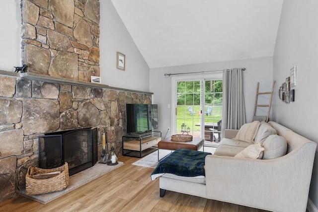 649 Robin Hill St, Marlborough, MA 01752 - living area with a stone fireplace, wood finished floors, and high vaulted ceiling