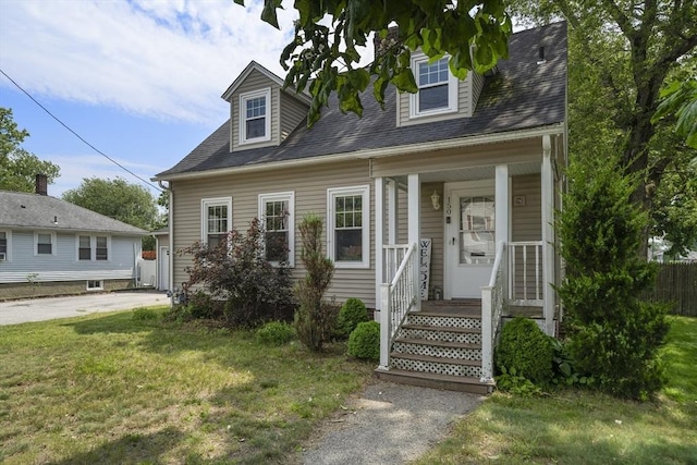 150 Church Ave, Warwick, RI 02889 - new england style home with a front lawn, a porch, and a shingled roof