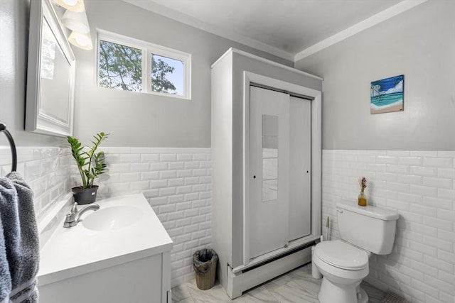 150 Church Ave, Warwick, RI 02889 - bathroom featuring tile walls, vanity, marble look tiles, baseboard heating, and wainscoting