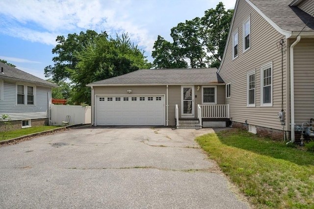 150 Church Ave, Warwick, RI 02889 - view of front facade with asphalt driveway, an attached garage, and a front lawn
