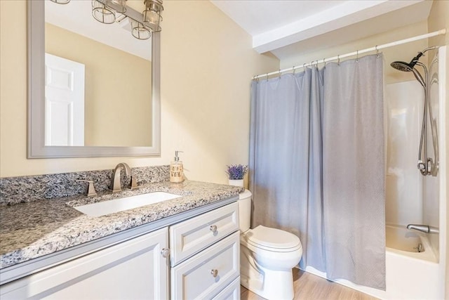 full bathroom with wood finished floors, toilet, shower / bath combo, and vanity