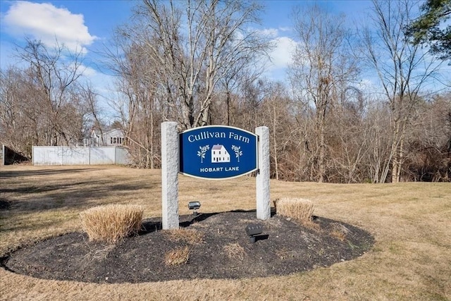 community sign with a yard and fence