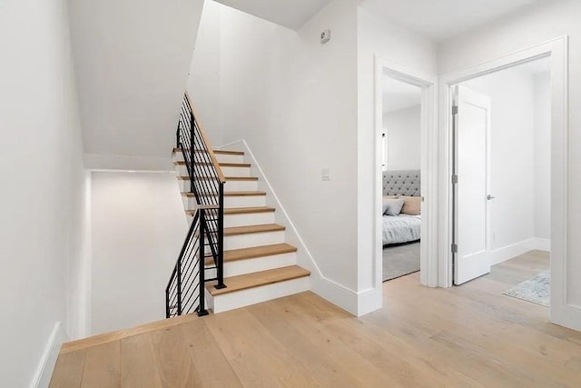 stairs with hardwood / wood-style floors