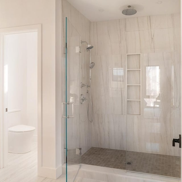 bathroom featuring an enclosed shower and toilet