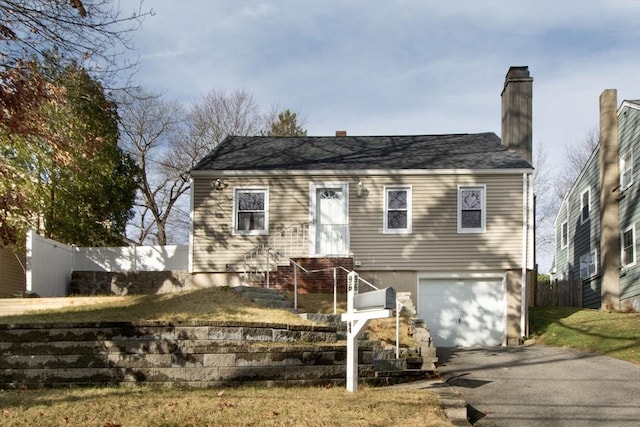 view of front of property with a front yard and a garage