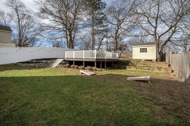 view of yard featuring a storage shed and a deck