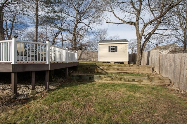 view of yard featuring a shed and a deck