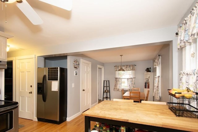 dining area featuring light hardwood / wood-style flooring and ceiling fan