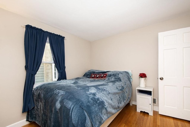 bedroom with hardwood / wood-style flooring